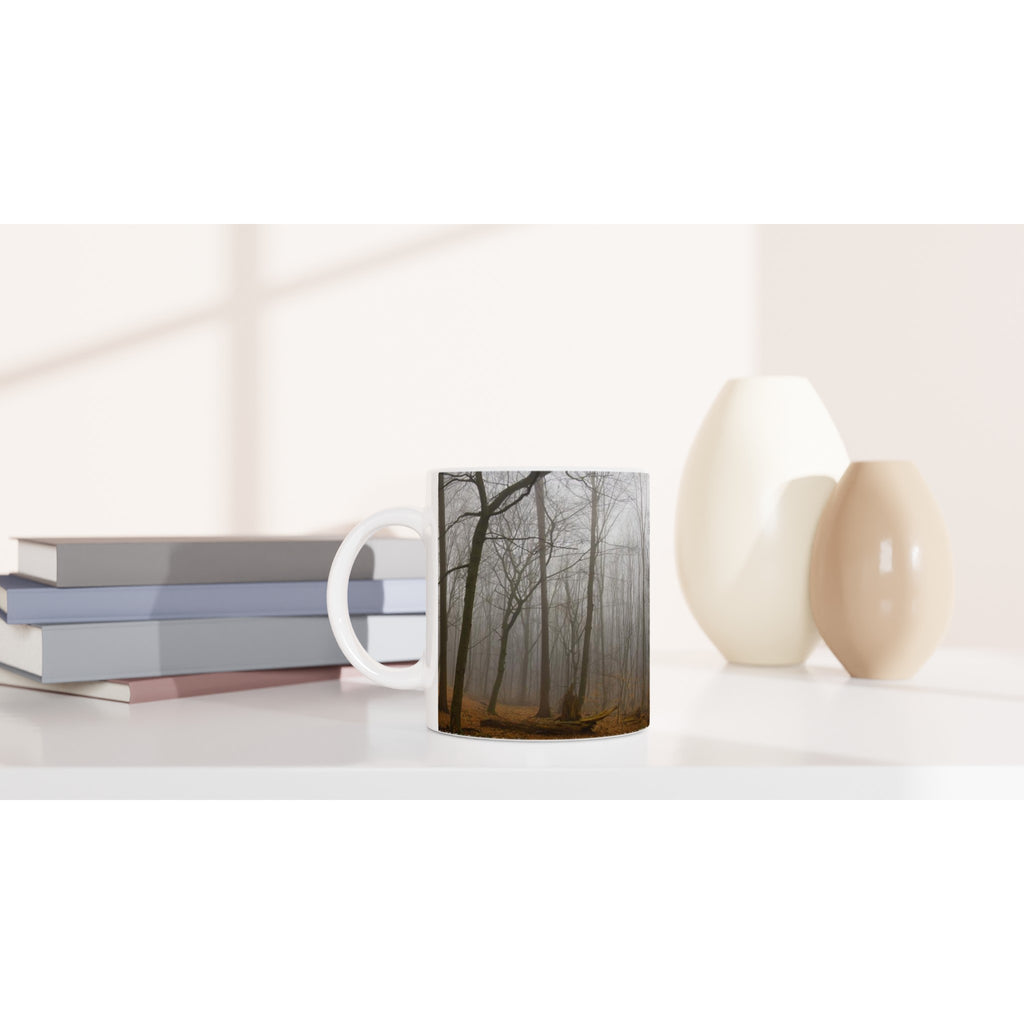 Atmospheric nature photography of a silent forest in morning mist, printed on a premium white ceramic mug for a mindful coffee or tea moment.